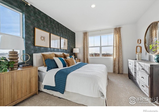 2239 Base St, Fort Lupton, CO 80621 - bedroom featuring wallpapered walls, light colored carpet, an accent wall, and recessed lighting