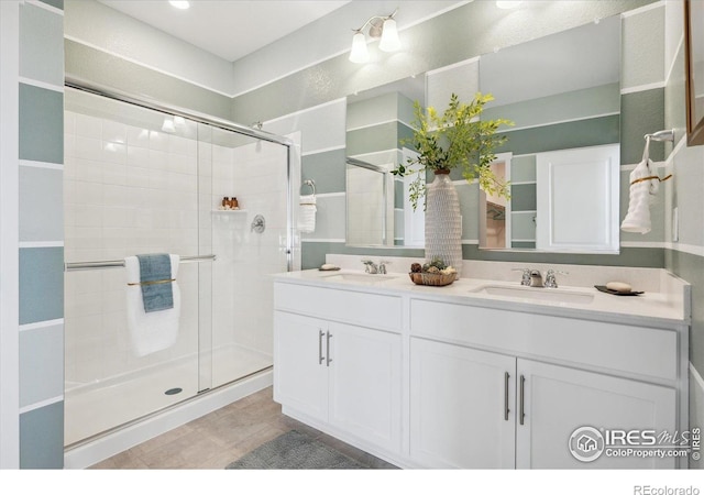2239 Base St, Fort Lupton, CO 80621 - bathroom featuring a stall shower, double vanity, and tile patterned flooring