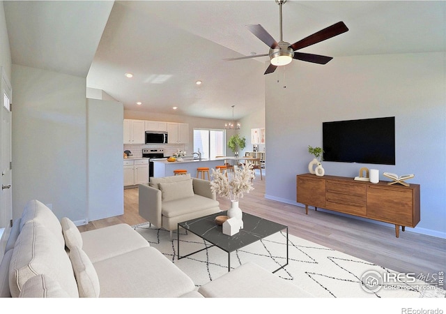4315 Primrose Ln, Evans, CO 80620 - living area featuring light wood-style floors, ceiling fan, recessed lighting, a chandelier, and vaulted ceiling