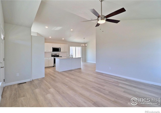 4315 Primrose Ln, Evans, CO 80620 - unfurnished living room featuring a ceiling fan, a chandelier, recessed lighting, light wood-type flooring, and vaulted ceiling