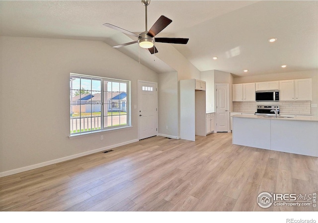 4315 Primrose Ln, Evans, CO 80620 - unfurnished living room with light wood-style flooring, a ceiling fan, lofted ceiling, and recessed lighting
