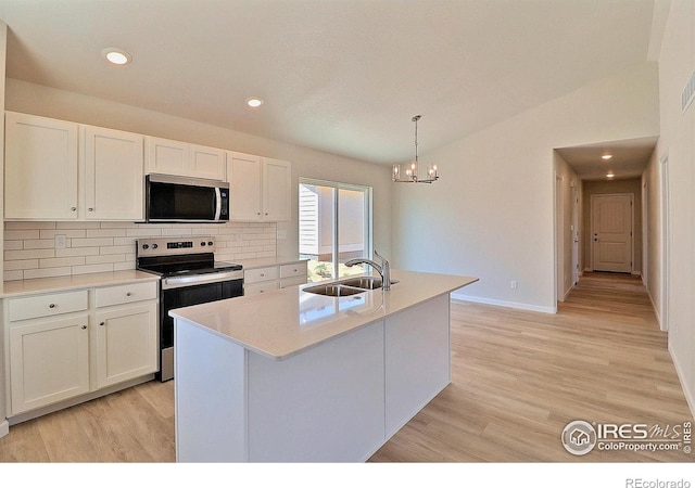 4315 Primrose Ln, Evans, CO 80620 - kitchen featuring appliances with stainless steel finishes, decorative backsplash, white cabinets, recessed lighting, and vaulted ceiling