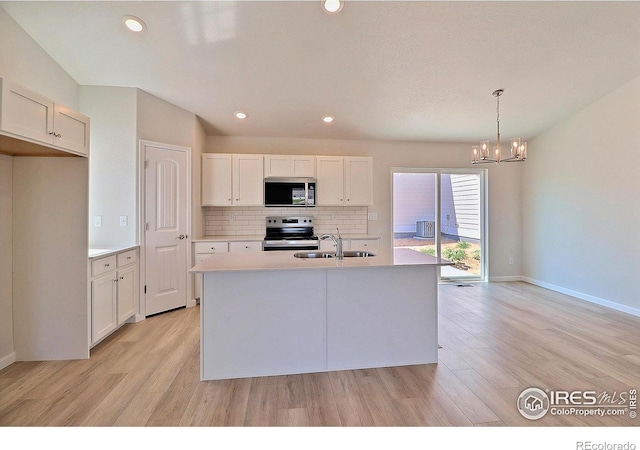 4315 Primrose Ln, Evans, CO 80620 - kitchen with appliances with stainless steel finishes, a chandelier, backsplash, light wood finished floors, and light countertops