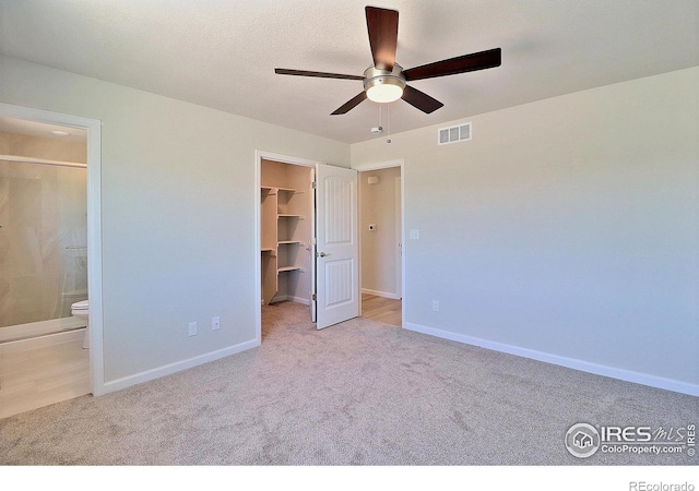4315 Primrose Ln, Evans, CO 80620 - unfurnished bedroom with carpet, a spacious closet, ensuite bath, and a ceiling fan