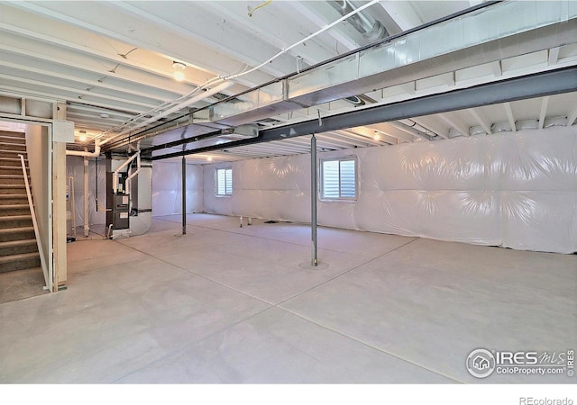 4315 Primrose Ln, Evans, CO 80620 - below grade area featuring heating unit and stairway