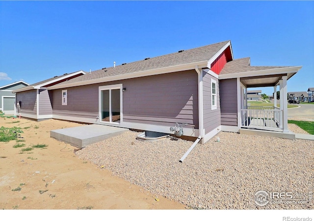 4315 Primrose Ln, Evans, CO 80620 - back of property with a shingled roof, a patio area, and covered porch