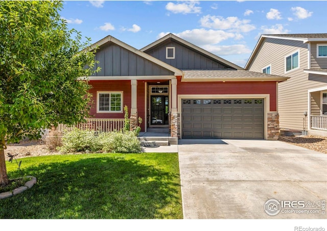 2968 Hydra Dr, Loveland, CO 80537 - craftsman house featuring board and batten siding, covered porch, driveway, a garage, and a front lawn