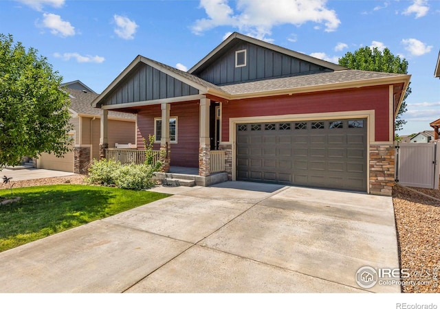 2968 Hydra Dr, Loveland, CO 80537 - craftsman-style house featuring board and batten siding, stone siding, covered porch, driveway, and a garage