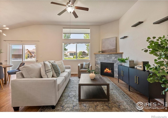 2968 Hydra Dr, Loveland, CO 80537 - living room featuring a fireplace, wood finished floors, ceiling fan, and vaulted ceiling