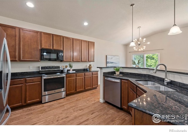 2968 Hydra Dr, Loveland, CO 80537 - kitchen with appliances with stainless steel finishes, lofted ceiling, decorative light fixtures, light wood-type flooring, and recessed lighting