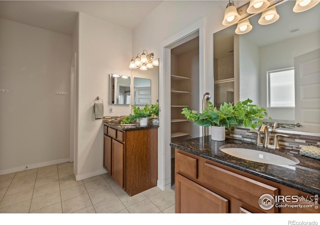 2968 Hydra Dr, Loveland, CO 80537 - bathroom featuring two vanities, tile patterned floors, and a shower with door