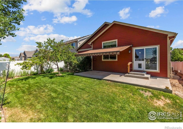 2968 Hydra Dr, Loveland, CO 80537 - back of property featuring a fenced backyard, a patio, entry steps, a metal roof, and a standing seam roof