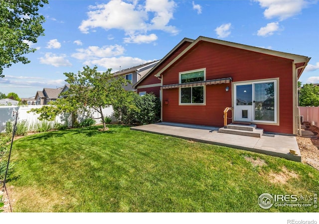 2968 Hydra Dr, Loveland, CO 80537 - back of property with a fenced backyard, entry steps, and a patio