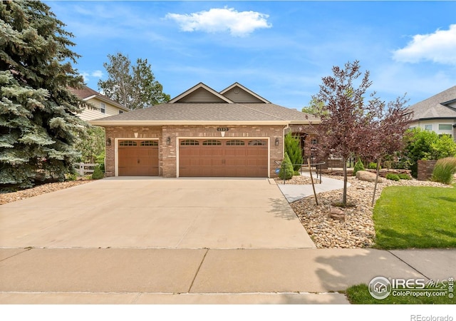 4283 Golf Vista Dr, Loveland, CO 80537 - view of front of home with brick siding, an attached garage, concrete driveway, and roof with shingles