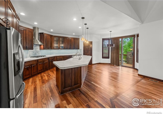 4283 Golf Vista Dr, Loveland, CO 80537 - kitchen with appliances with stainless steel finishes, wall chimney range hood, light countertops, dark wood-style floors, and recessed lighting