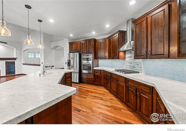 4283 Golf Vista Dr, Loveland, CO 80537 - kitchen with appliances with stainless steel finishes, wall chimney range hood, light wood-style flooring, light countertops, and tasteful backsplash
