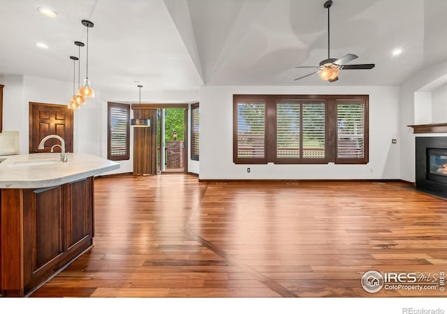 4283 Golf Vista Dr, Loveland, CO 80537 - unfurnished living room featuring hardwood / wood-style floors, a fireplace with flush hearth, recessed lighting, and ceiling fan
