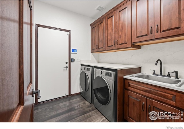 4283 Golf Vista Dr, Loveland, CO 80537 - laundry room with washer and dryer, cabinet space, and dark wood-type flooring