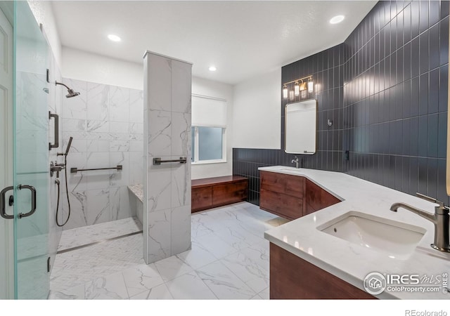 4283 Golf Vista Dr, Loveland, CO 80537 - full bath featuring double vanity, a marble finish shower, tile walls, marble look tiles, and recessed lighting