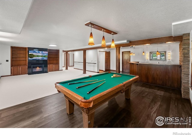 4283 Golf Vista Dr, Loveland, CO 80537 - playroom featuring a textured ceiling, a warm lit fireplace, wood finished floors, billiards, and built in features