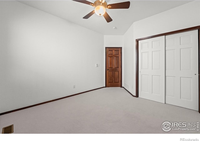 4283 Golf Vista Dr, Loveland, CO 80537 - unfurnished bedroom featuring light colored carpet, a closet, vaulted ceiling, and a ceiling fan