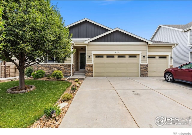 1625 Glacier Ave, Berthoud, CO 80513 - craftsman-style house with an attached garage, concrete driveway, a front yard, stone siding, and board and batten siding