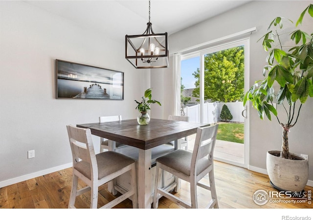 1625 Glacier Ave, Berthoud, CO 80513 - dining room with a chandelier and light wood-style flooring