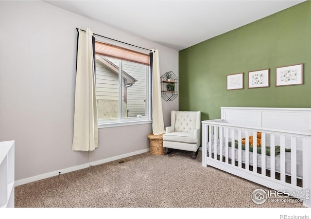 1625 Glacier Ave, Berthoud, CO 80513 - bedroom featuring carpet floors and a crib