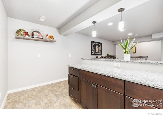 1625 Glacier Ave, Berthoud, CO 80513 - kitchen with dark brown cabinets, pendant lighting, light stone countertops, recessed lighting, and open shelves