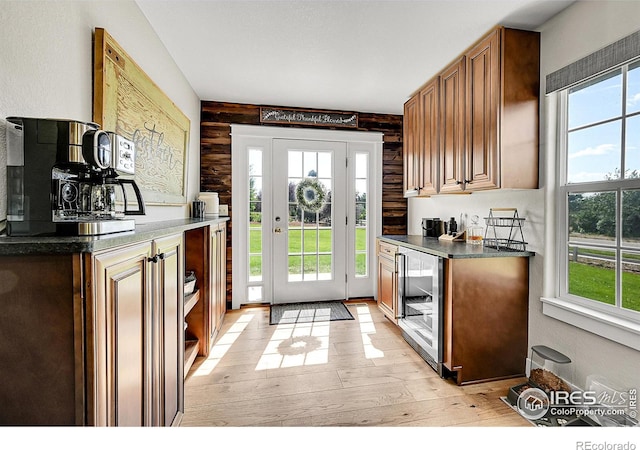 1115 Kestrel Rd, Eaton, CO 80615 - kitchen featuring beverage cooler, light wood finished floors, and dark countertops