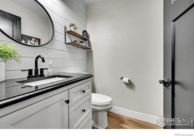1115 Kestrel Rd, Eaton, CO 80615 - bathroom with wood finished floors, vanity, and wood walls