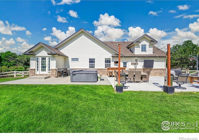 1115 Kestrel Rd, Eaton, CO 80615 - back of house featuring a patio, a hot tub, brick siding, and roof with shingles
