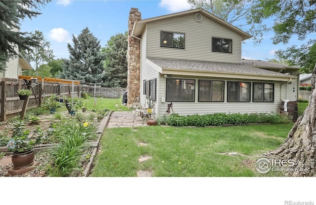 2937 Alamo Ave, Fort Collins, CO 80525 - rear view of property with roof with shingles, a chimney, and a fenced backyard
