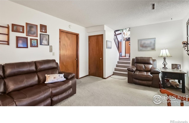 2937 Alamo Ave, Fort Collins, CO 80525 - carpeted living area with stairway and a textured ceiling