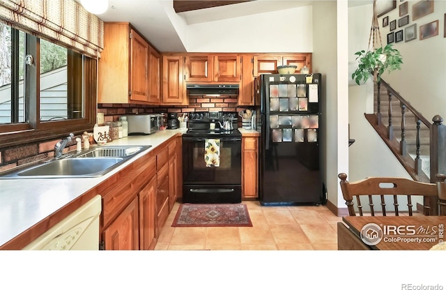 2937 Alamo Ave, Fort Collins, CO 80525 - kitchen featuring black appliances, decorative backsplash, light countertops, brown cabinetry, and light tile patterned floors