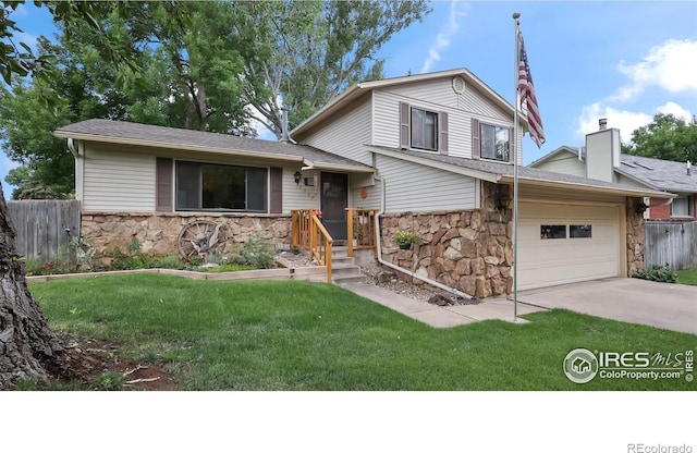 2937 Alamo Ave, Fort Collins, CO 80525 - tri-level home featuring stone siding, driveway, an attached garage, roof with shingles, and a chimney