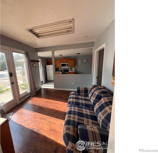 1031 N Lincoln Ave, Loveland, CO 80537 - living area featuring a textured ceiling and dark wood-type flooring