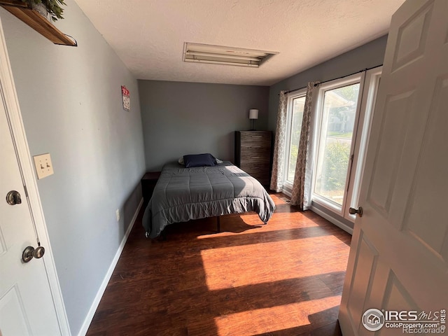 1031 N Lincoln Ave, Loveland, CO 80537 - bedroom with wood finished floors and a textured ceiling