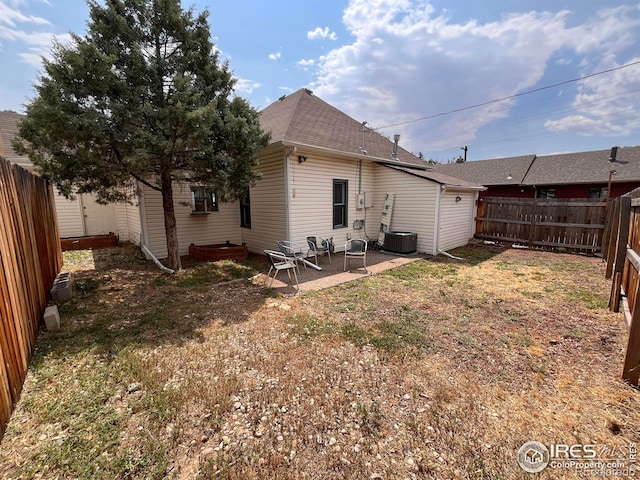 1031 N Lincoln Ave, Loveland, CO 80537 - back of property with a fenced backyard, roof with shingles, and a patio