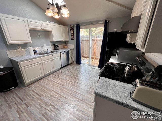1031 N Lincoln Ave, Loveland, CO 80537 - kitchen with black electric range, dishwasher, wall chimney range hood, vaulted ceiling, and a chandelier
