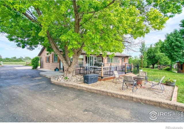1400 Darton Dr, Johnstown, CO 80534 - view of front of property with an outdoor fire pit and a patio area