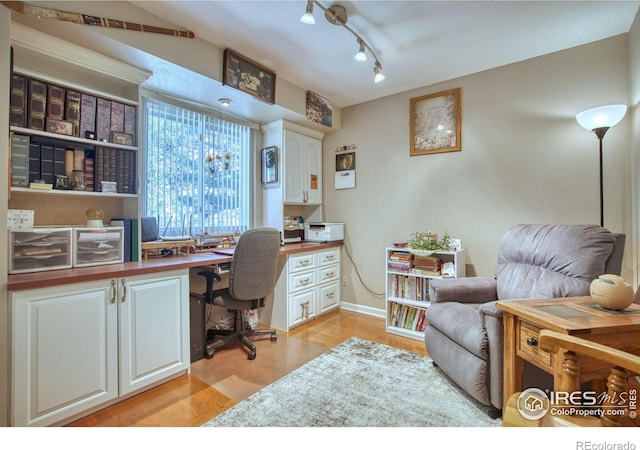 1400 Darton Dr, Johnstown, CO 80534 - office space with built in study area, light wood-style flooring, and rail lighting