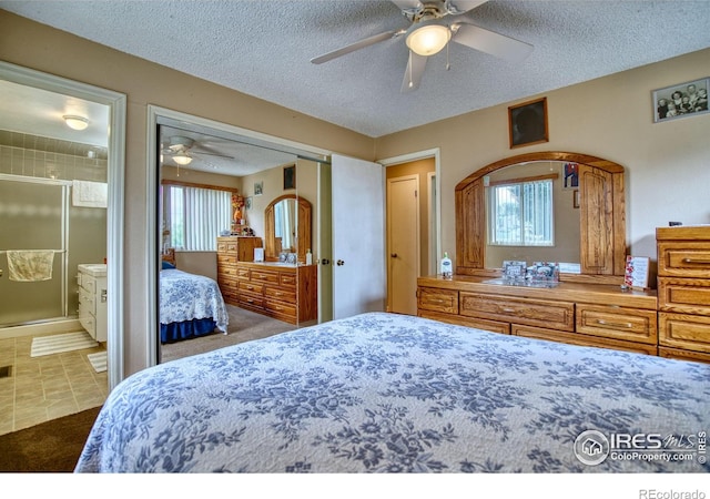 1400 Darton Dr, Johnstown, CO 80534 - bedroom featuring a textured ceiling, connected bathroom, a ceiling fan, carpet floors, and a closet