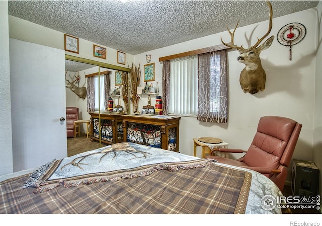 1400 Darton Dr, Johnstown, CO 80534 - bedroom with a textured ceiling, a closet, and carpet flooring