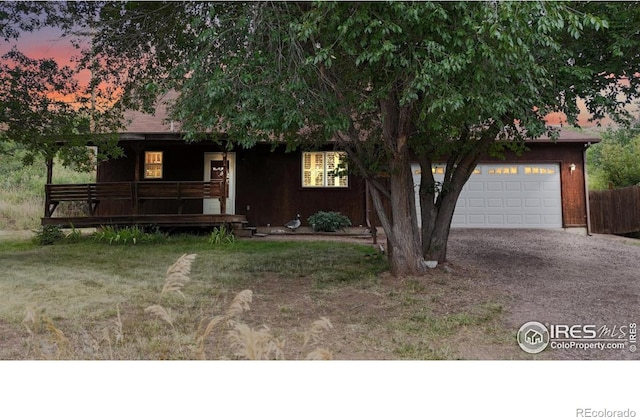 5001 W County Road 38 E, Fort Collins, CO 80526 - view of front of house featuring a porch, gravel driveway, and a garage
