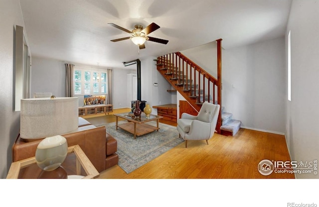 5001 W County Road 38 E, Fort Collins, CO 80526 - living room with ceiling fan, wood finished floors, stairway, and a wood stove