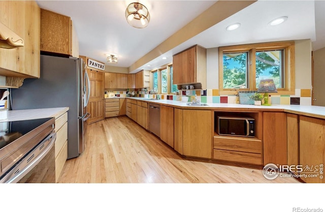 2319 Cotswold Ct, Fort Collins, CO 80526 - kitchen featuring appliances with stainless steel finishes, light wood-style flooring, tile countertops, and recessed lighting