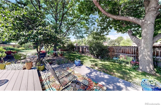 2319 Cotswold Ct, Fort Collins, CO 80526 - fenced backyard featuring a deck and a patio area