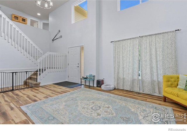 1169 Cooke Ct, Erie, CO 80516 - entrance foyer featuring a high ceiling, wood finished floors, stairs, and a chandelier
