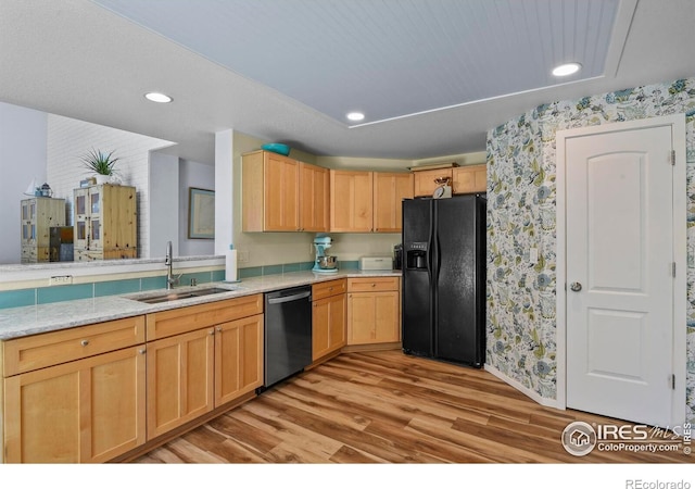 1169 Cooke Ct, Erie, CO 80516 - kitchen with black fridge with ice dispenser, stainless steel dishwasher, light brown cabinets, light wood-type flooring, and wallpapered walls